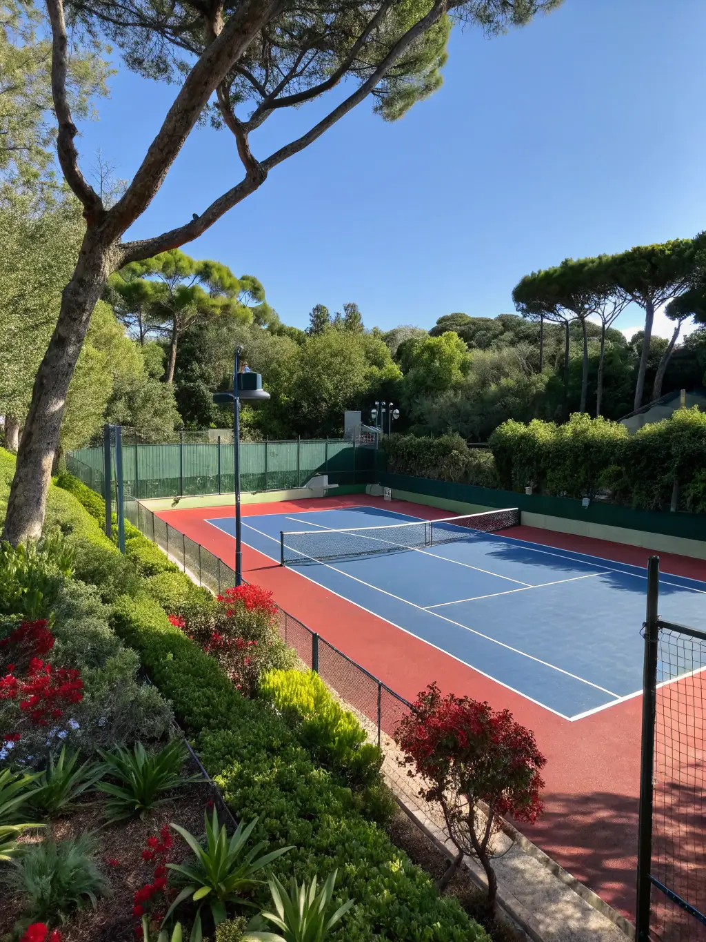 An aerial view of a newly constructed tennis court by Paballo Covenant, highlighting the quality of the playing surface and surrounding landscaping.